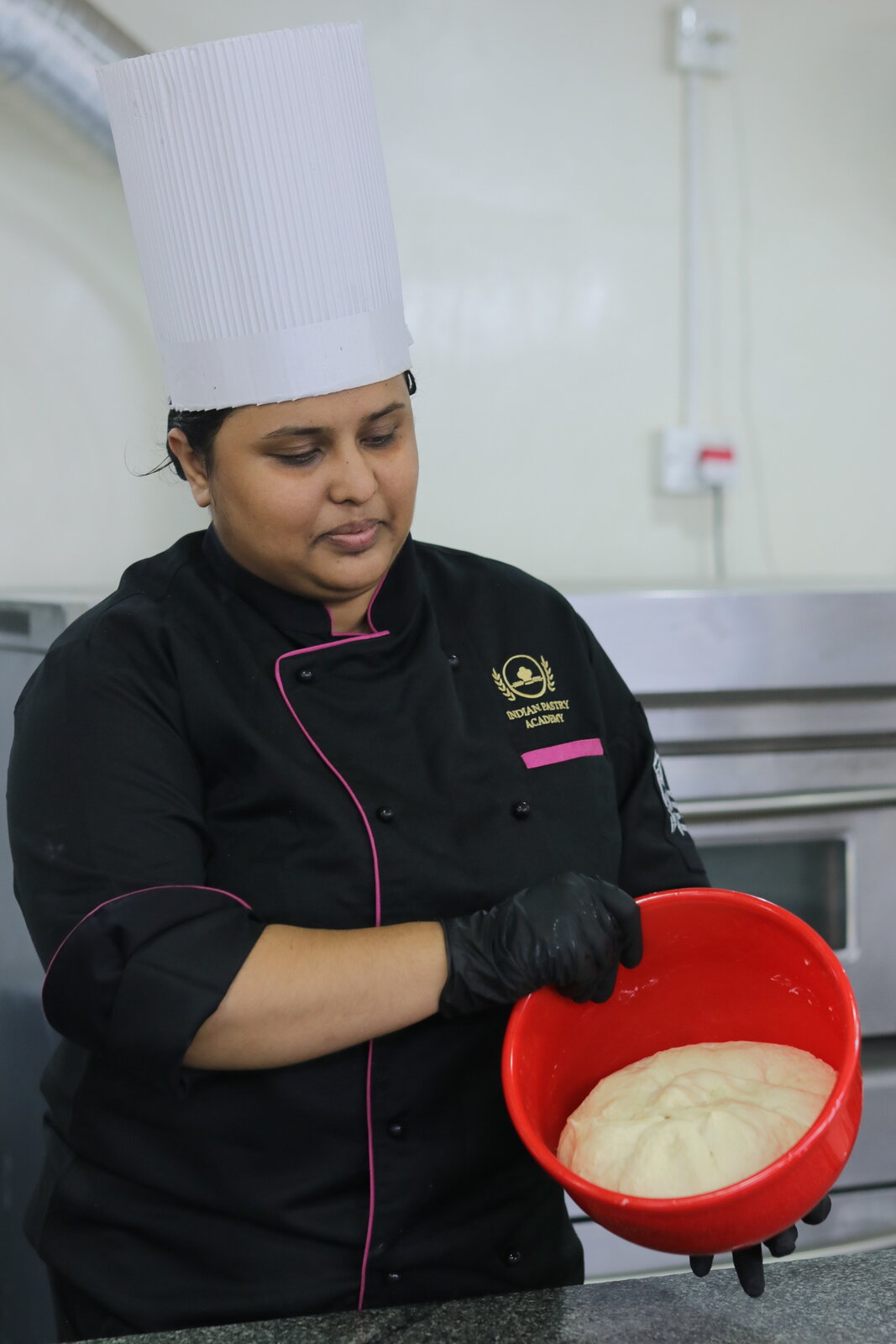 Indian Pastry Academy student checking proofed dough before baking