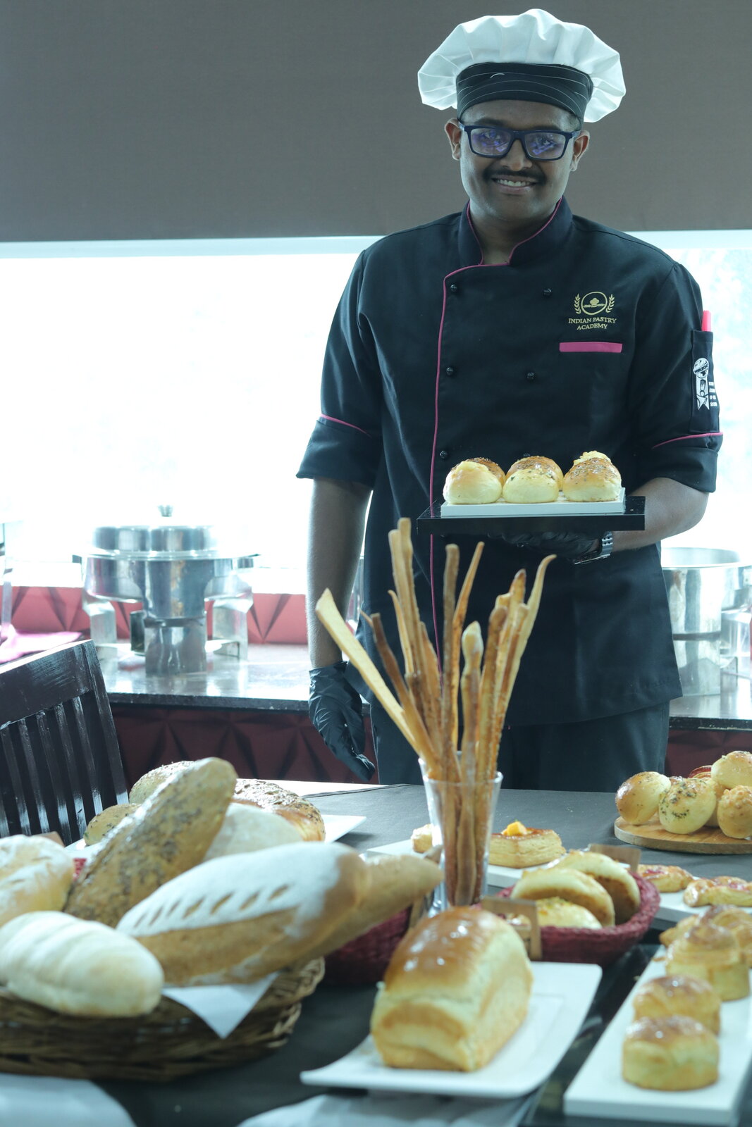 Indian Pastry Academy student presenting a pastry and bakery buffet spread